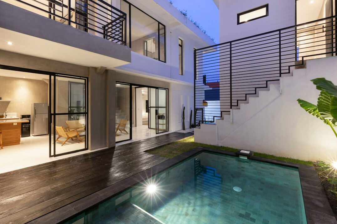 Contemporary villa with swimming pool surrounded by pine trees