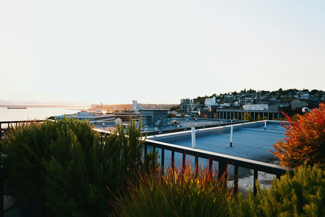 Modern penthouse terrace overlooking a coastal city skyline