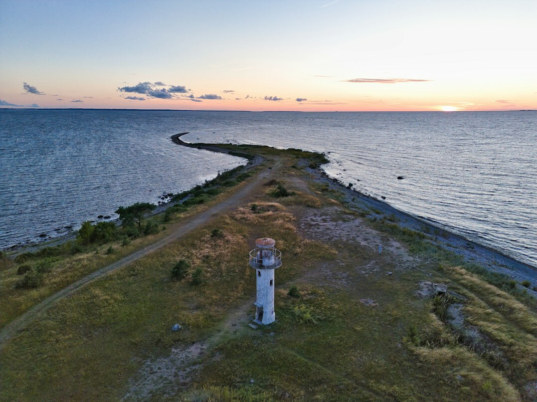 Lighthouse on a quiet peninsula at sunset