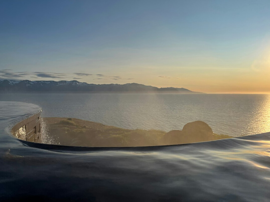 Close-up of an empty infinity pool edge at sunset